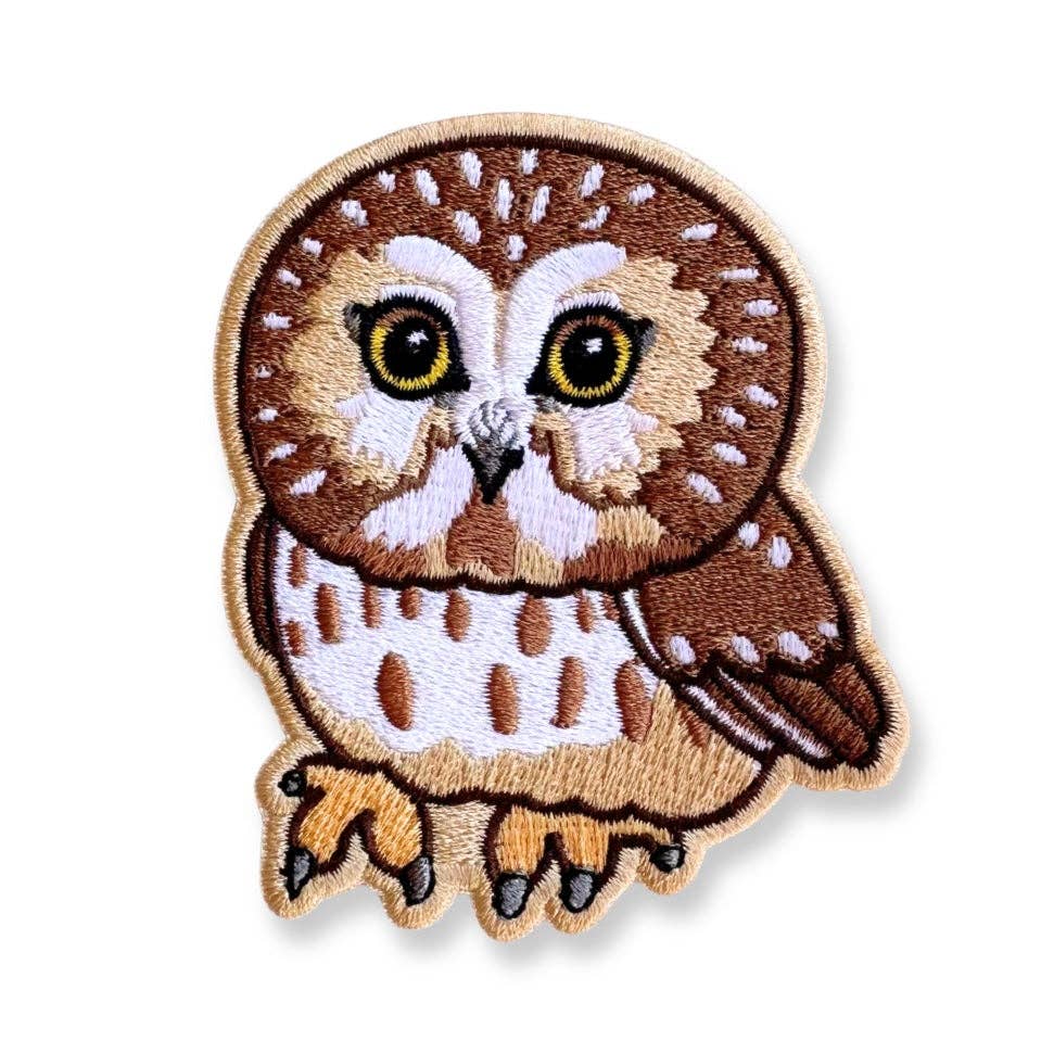 Saw-whet Owl Iron-On Embroidered Patch featuring a brown and tan owl with large yellow eyes.
