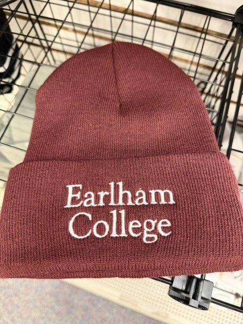 The Maroon Earlham College Beanie is displayed on a wire rack.