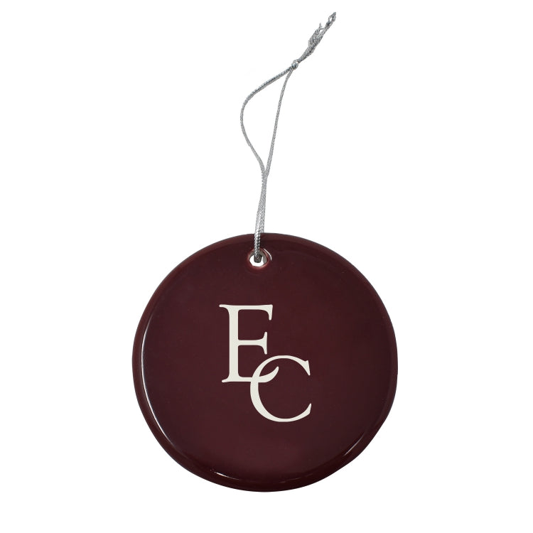 Round maroon ornament with 'EC' initials on it.