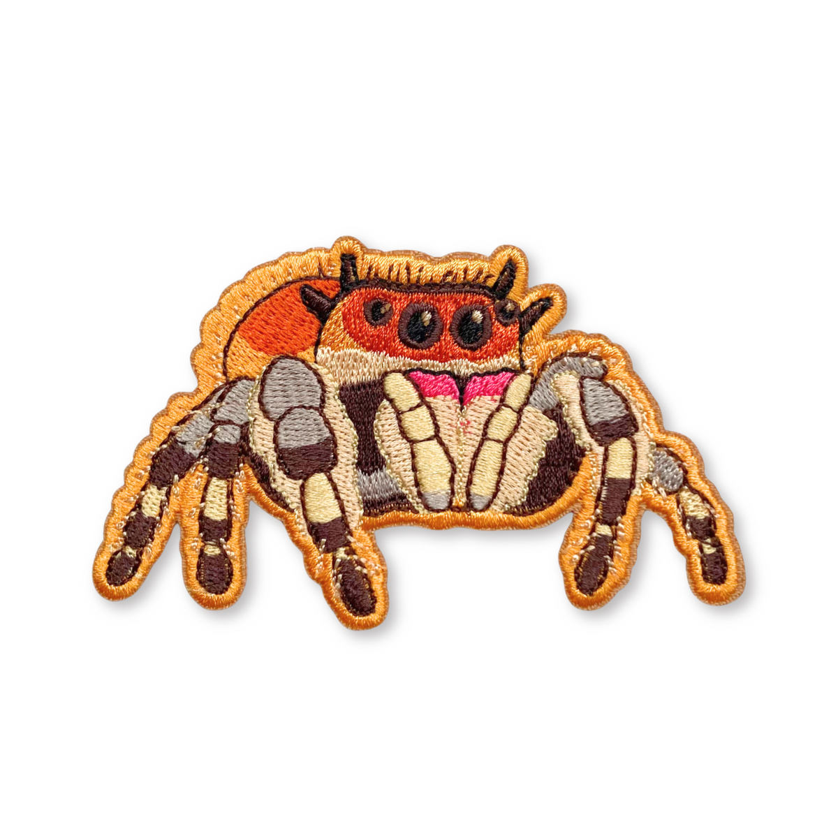 Regal Jumping Spider iron-on embroidered patch featuring orange, brown, and cream-colored markings.