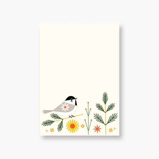 Chickadee notepad printed in Seattle featuring an illustration of a chickadee perched on a pine branch with stylized flowers and greenery along the bottom.