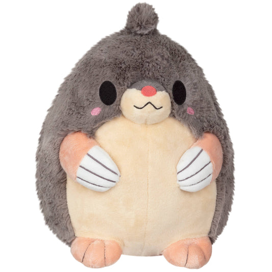 Meet the Mini Squishable Mole: a cute plush with gray fur, a beige belly, peach-colored paws, pink cheeks, a red nose, and a tuft of fur on its head—perfect as your new companion!.