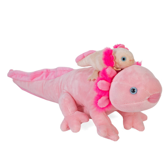 A large pink Mom & Baby Axolotl 9" plush with a smiling face lies on its belly, while a smaller matching axolotl sits on its head. Both have frilly gills and blue eyes, making these sustainable toys both adorable and environmentally friendly.
