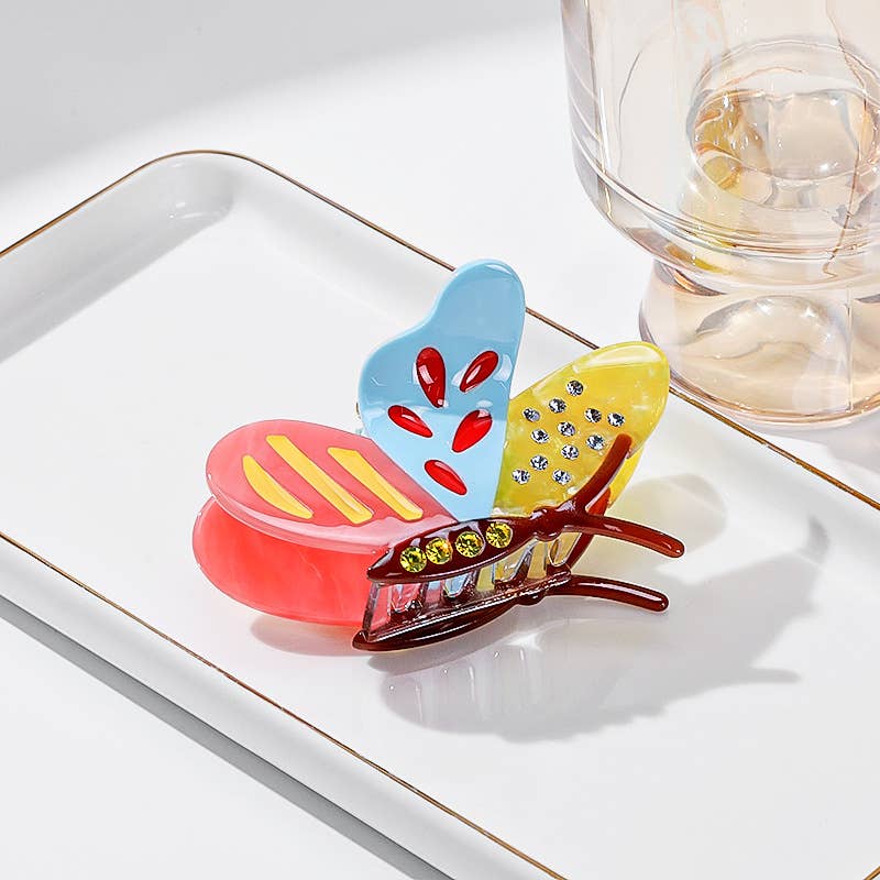 Side Butterfly Hair Claw Clip with colorful enamel wings and inset decorative stones.