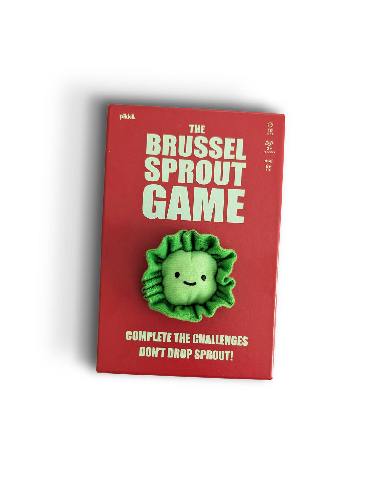 The Sprout Game | Hilarious Family Party Game box is red and features a plush green brussels sprout character attached to the center, with challenge cards and instructions printed on the cover.