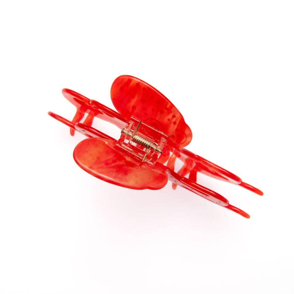 Translucent red Octopus Claw Clip with a spring mechanism.