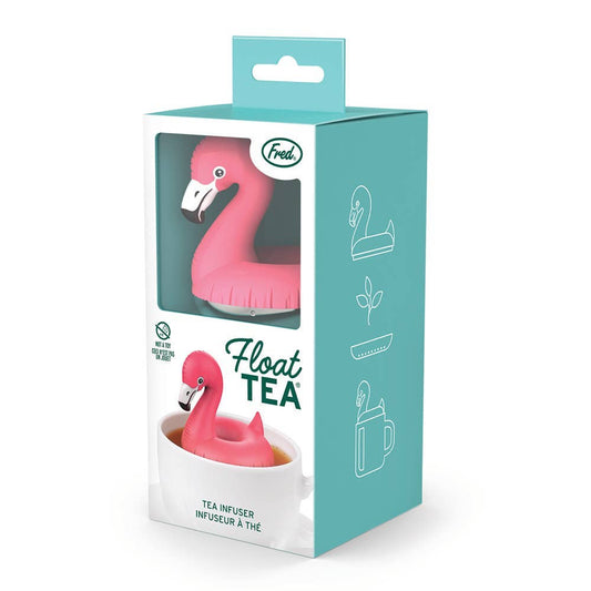 A Float - Tea - Pool Flamingo Infuser stainless steel pink flamingo resting in a tea cup, shown inside its product packaging.