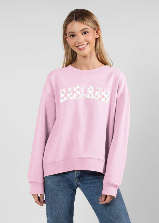 a pink sweatshirt with a white floral Earlham design on the chest