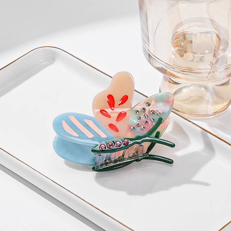 Side Butterfly Hair Claw Clip in a pastel butterfly shape with pink and silver rhinestone accents, designed as an eco-friendly hair accessory.