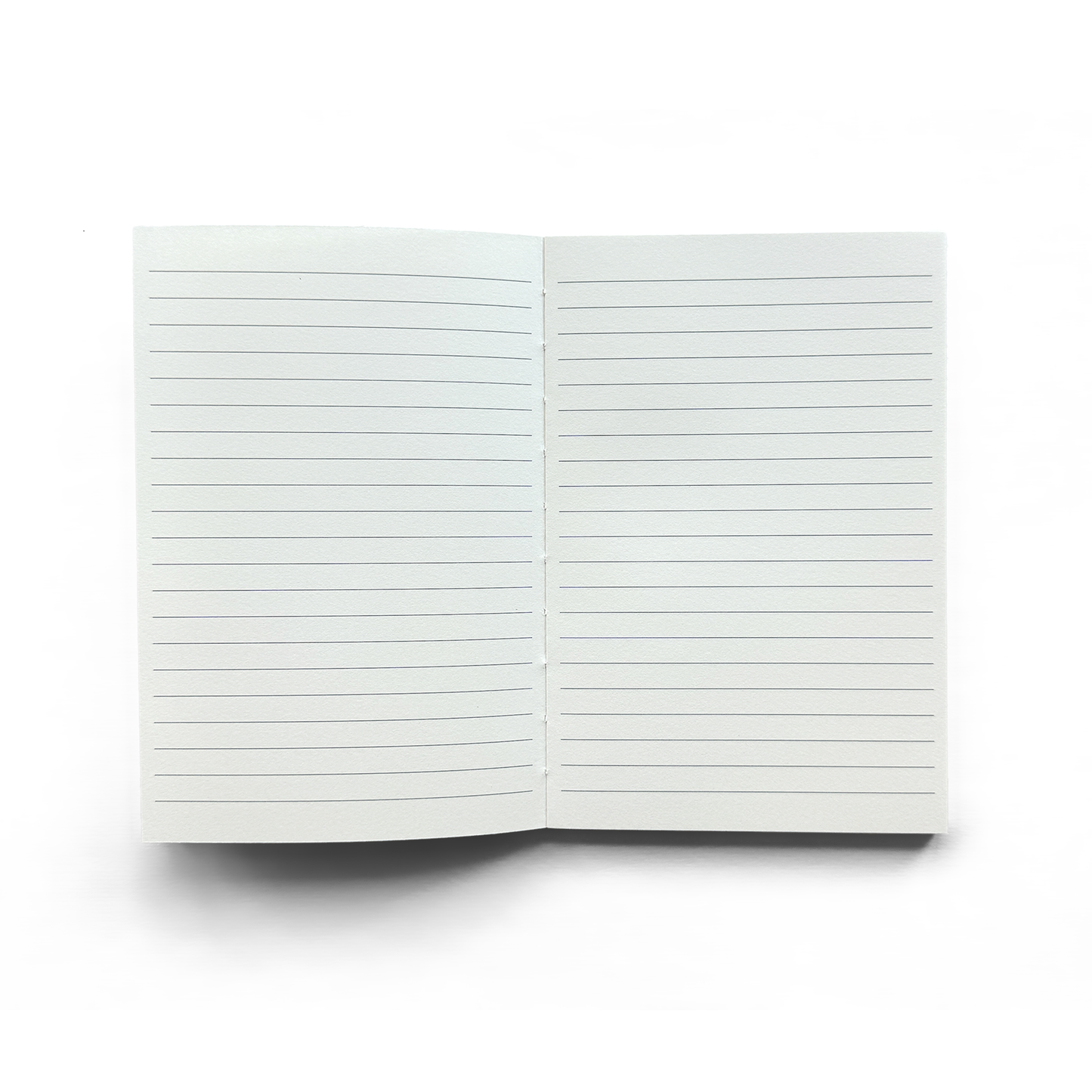 The Vintage Black Mushroom Exposed Coptic Binding Notebook is shown open from above on a white background, displaying two blank, lined pages with evenly spaced horizontal lines and no markings.