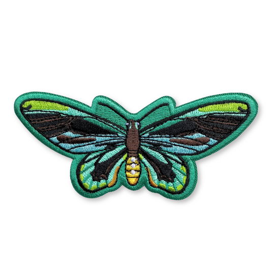 Queen Alexandra’s Birdwing Butterfly Iron-On Embroidered Patch featuring bright green, light blue, and black wings with a brown and yellow body.