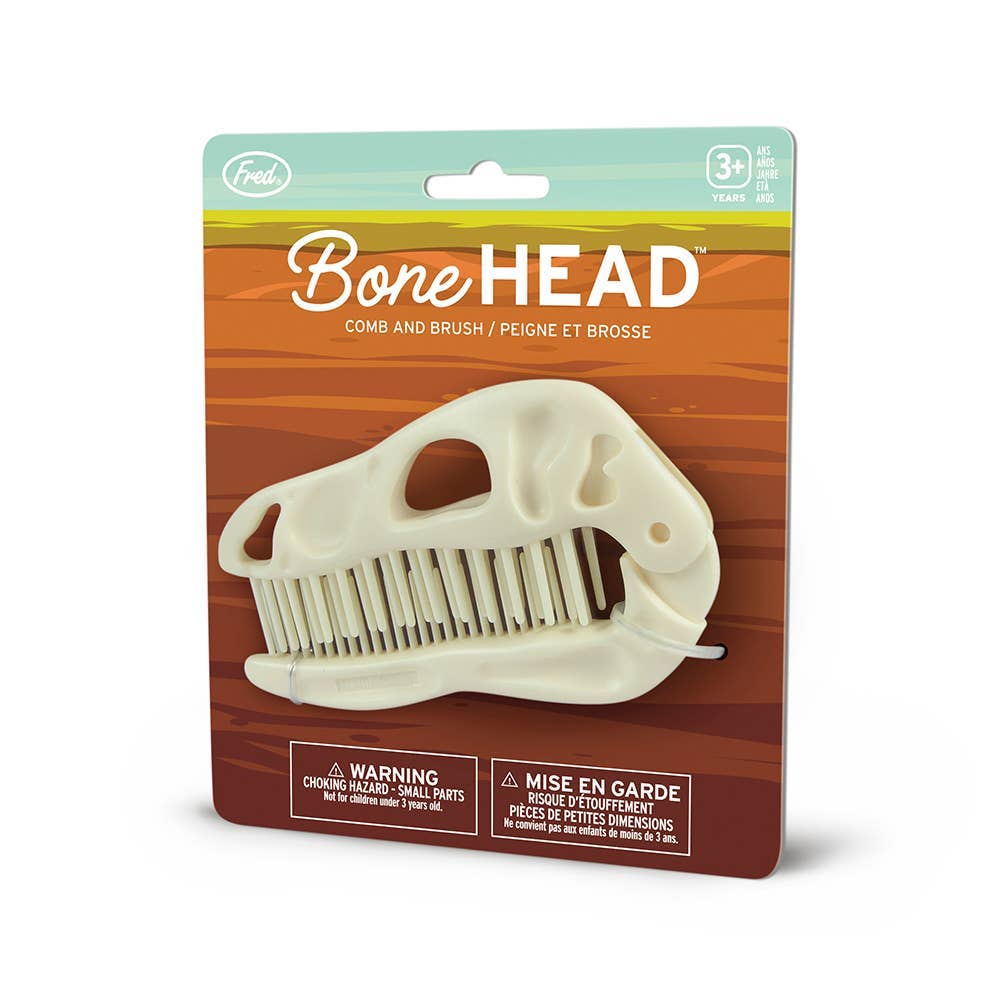 Packaging for dino skull-shaped Fred BoneHEAD dual comb and brush