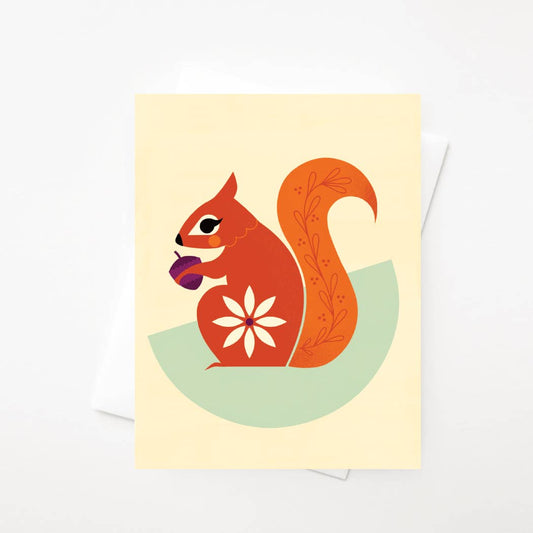 Red Squirrel Card featuring a stylized red squirrel holding a purple acorn, with a white flower pattern on its body and leaf designs on its tail, printed on heavy card stock.