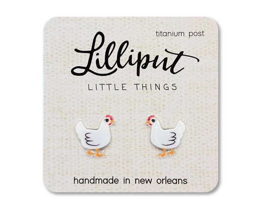Square earring card displaying two white Chicken Earrings, shaped like chickens with orange beaks and feet. The card reads “Lilliput Little Things, handmade in New Orleans,” and features hypoallergenic titanium earring posts.