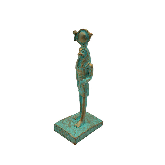 A striking Ra Statue Patina - 5″ - Egyptian God, featuring a turquoise and bronze finish, depicts the ancient Egyptian deity with a falcon head standing upright on a square base—a handmade Egypt souvenir and collectible figurine.