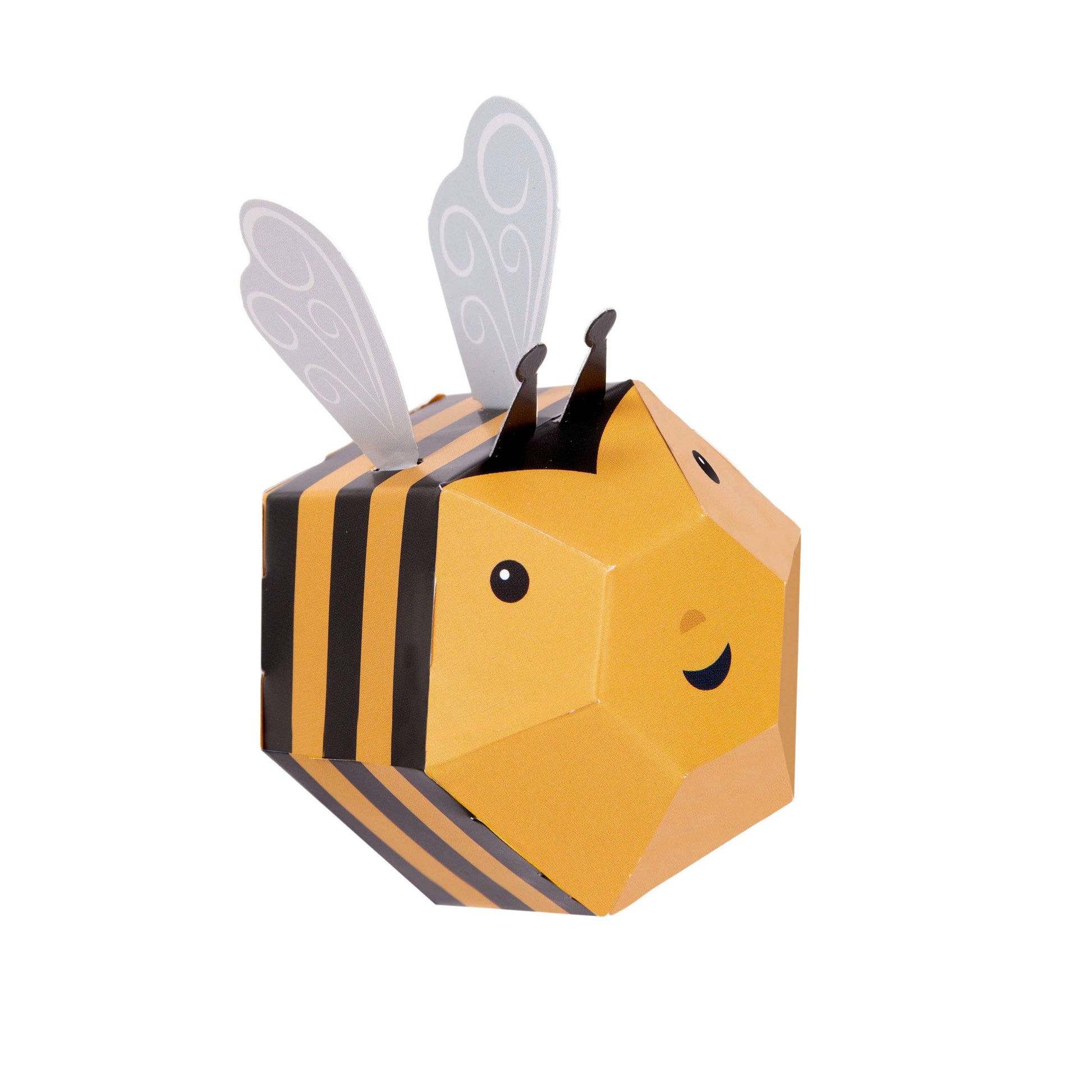 Create Your Own Buzzy Bumble Bee kit features a geometric, paper-crafted bee with black and yellow stripes, a smiling face, black antennae, and white wings—all plastic-free and shown on a white background.