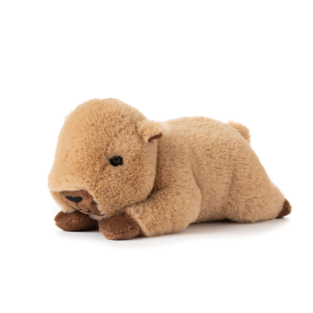 A soft, light brown Scoopz Capybara Small 8″ (21cm) plush toy is lying on its belly with its front paws stretched forward and features black embroidered eyes and nose, making it a charming addition to any safari nursery decor.