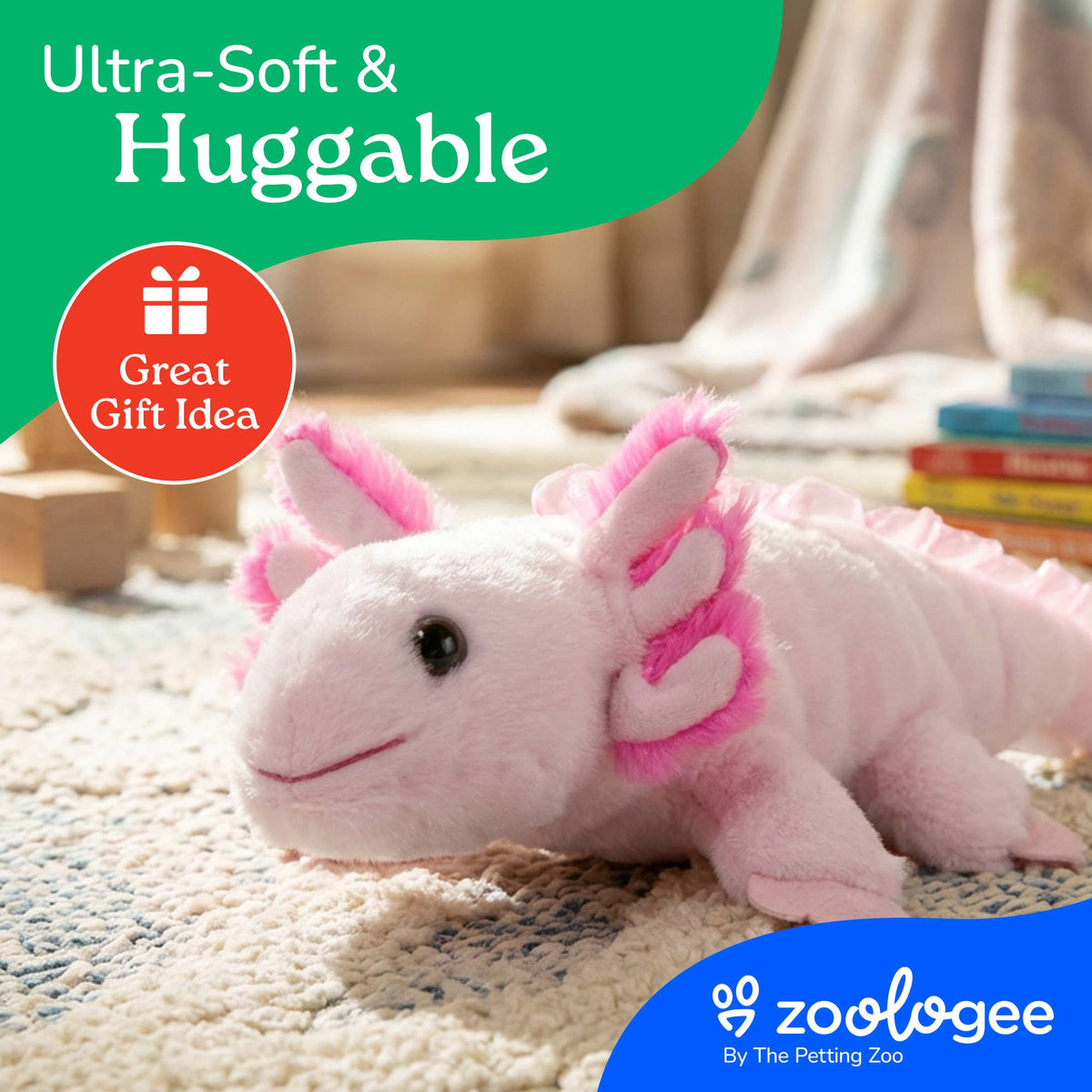 A Scoopz Axolotl Small 8″ (24cm) plushie in soft pink and white rests on a carpet surrounded by books. Text reads “Ultra-Soft & Huggable” and “Great Gift Idea.” The Zoologee logo appears in the corner.