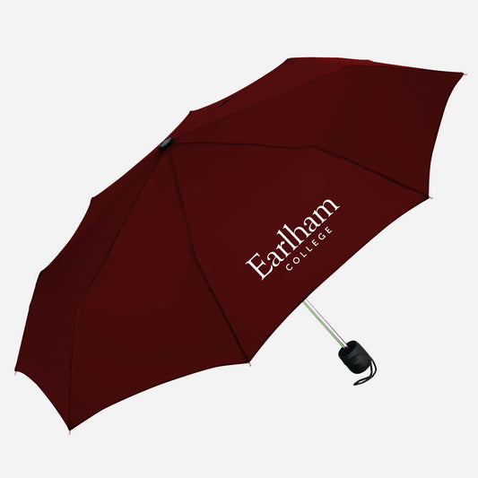 A maroon umbrella with a white Earlham College logo printed on one panel