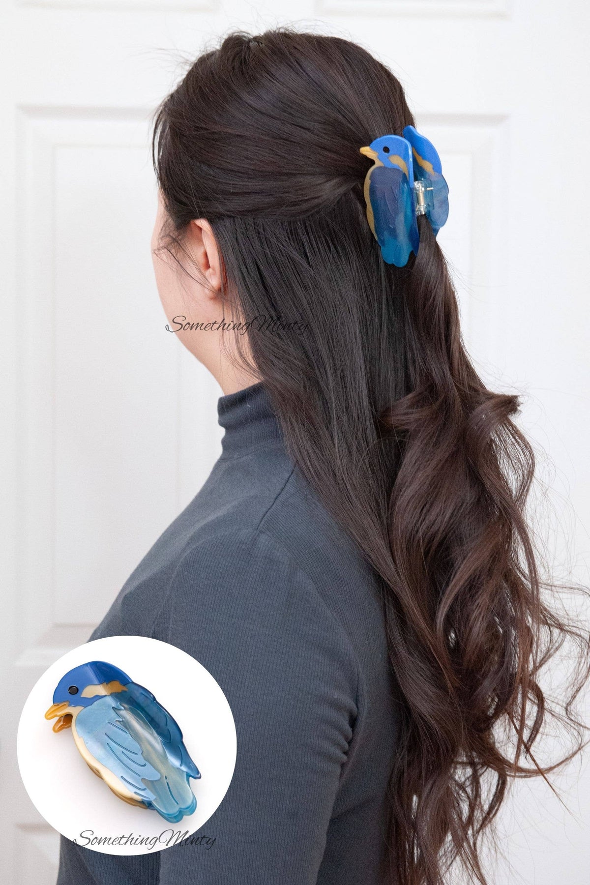 A person wearing a Blue Bird Hair Claw Clip, with a close-up of the eco-friendly acetate clip shown in an inset.