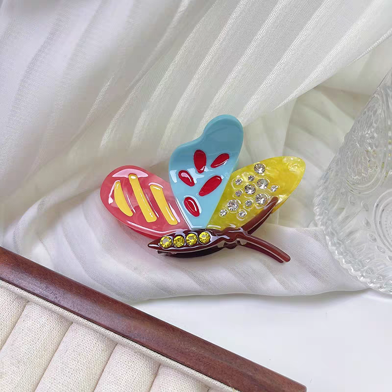 Side Butterfly Hair Claw Clip with colorful wings decorated with rhinestones and gems.