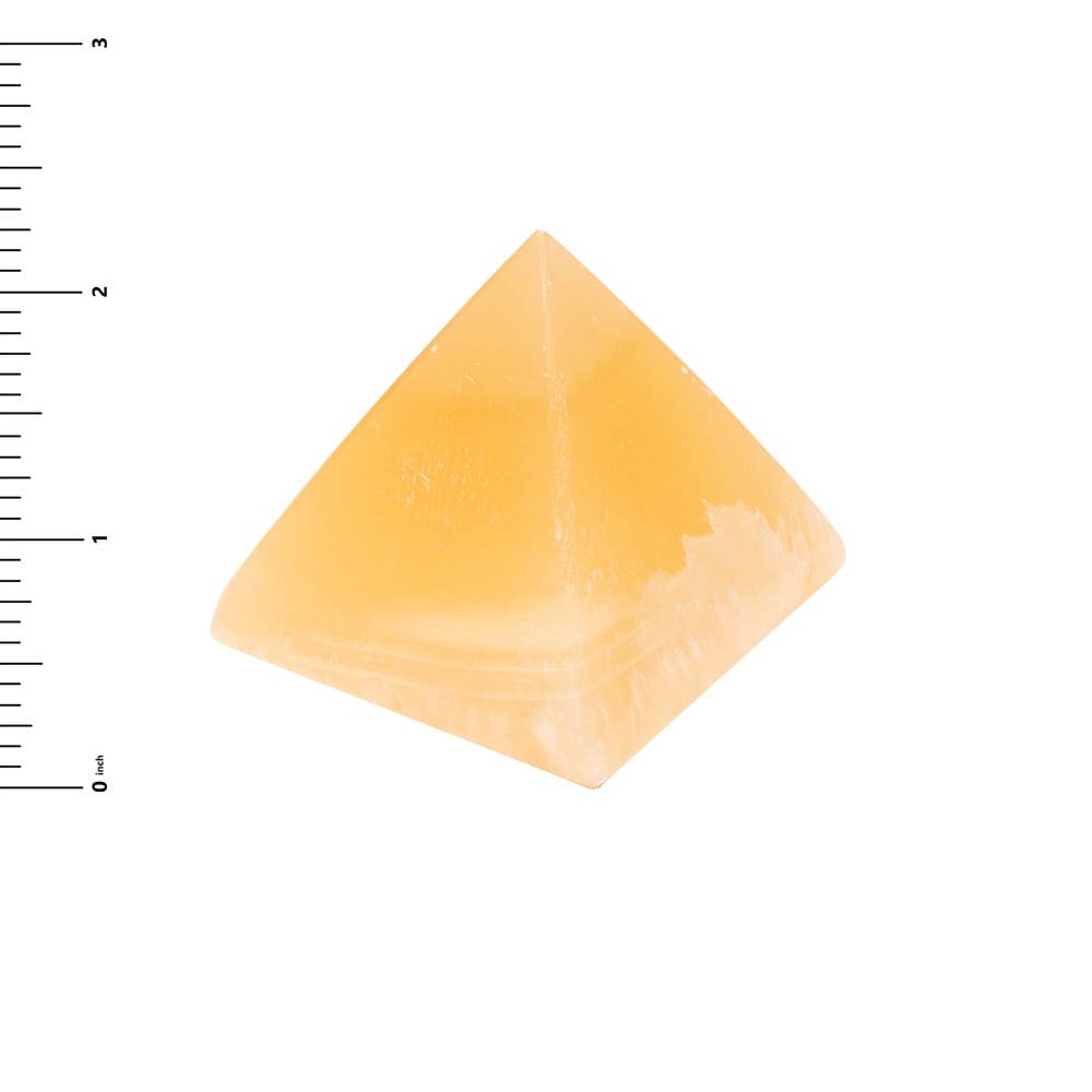 The Alabaster Pyramid - Small 2.25″, handmade in Egypt, is shown next to a vertical ruler for scale, measuring approximately 2.25 inches tall, on a white background.