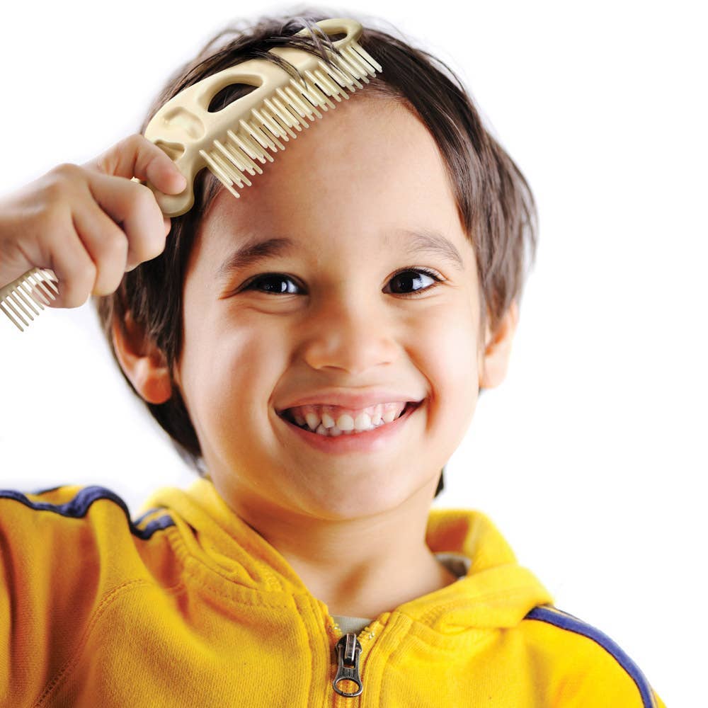 Child brushing their hair with the BoneHEAD dual brush and comb