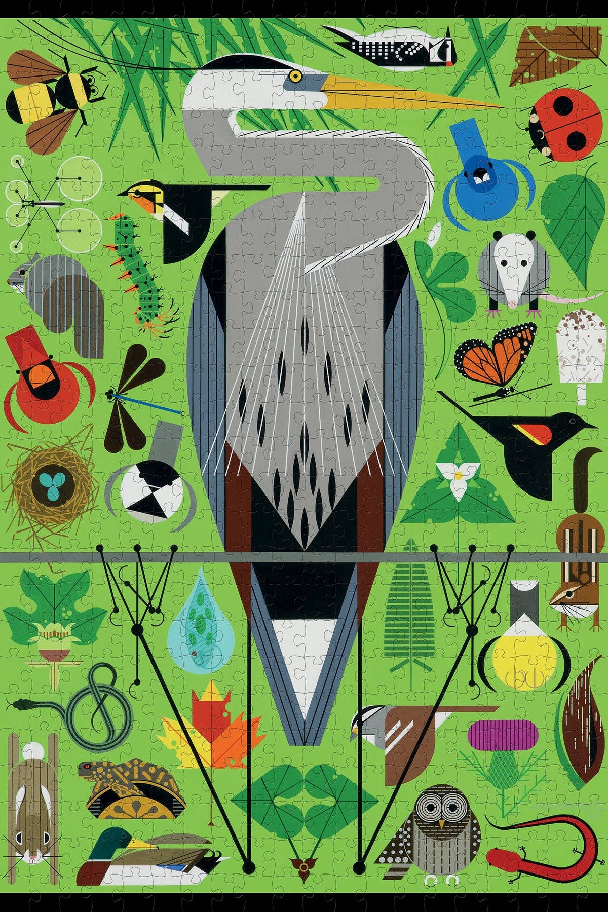 A large gray heron stands in the center of a Charley Harper: Secret Sanctuary 500-pieces puzzle field filled with illustrations of various insects, birds, animals, and plants.
