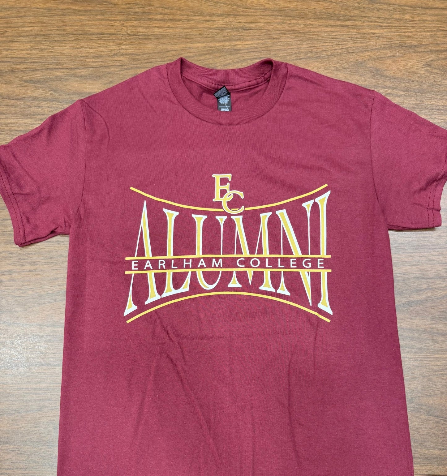 Maroon t-shirt with 'Earlham College Alumni' text in white and gold