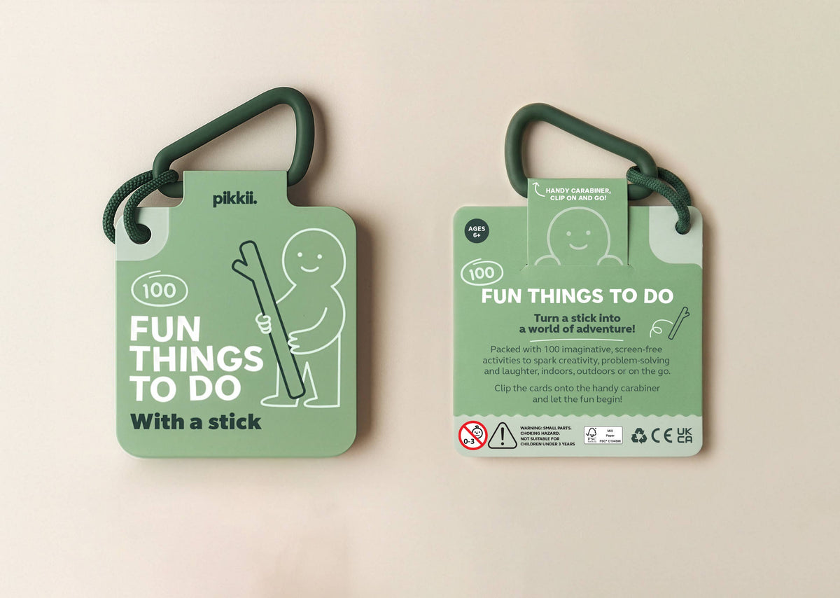 Two stacks of light green Fun Things to do with a stick | Play and Activity Cards attached to a dark green carabiner, featuring a cartoon character holding a stick and descriptive text for screen-free ideas.