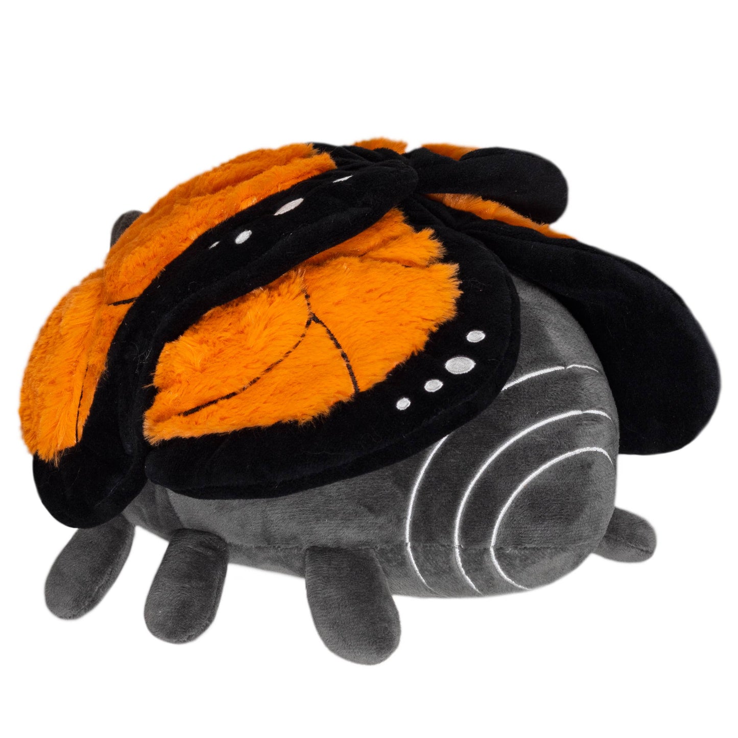 The Mini Squishable Monarch Butterfly is a squishy plush toy shaped like a bug, featuring a soft dark gray body, six legs, and bright orange and black wings—ideal for butterfly therapy or cozy cuddles.