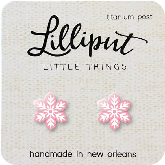 A pair of Pink Christmas Snowflake Earrings on a card labeled Lilliput Little Things, featuring hypoallergenic titanium posts and handmade in New Orleans.
