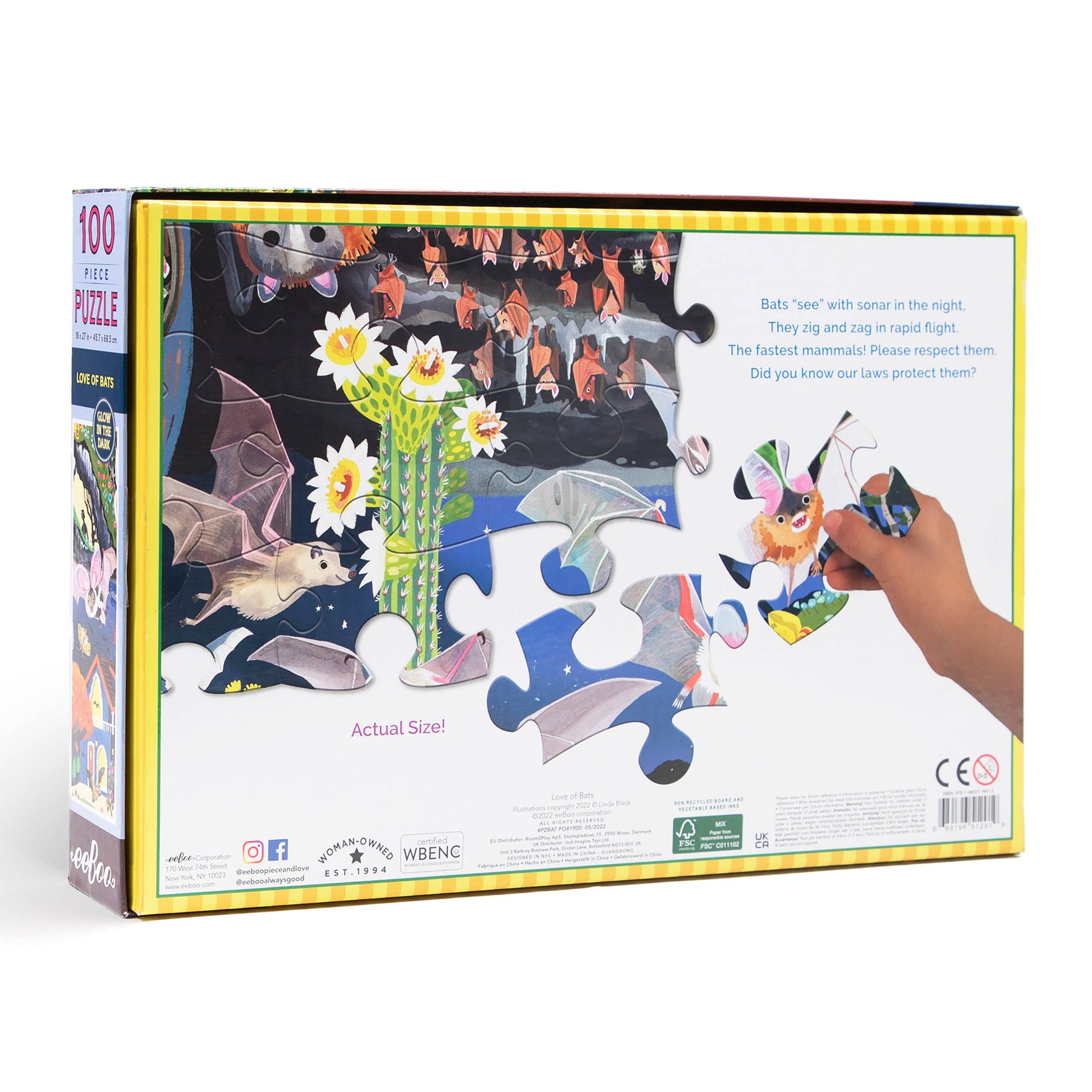 Back of the Love of Bats 100 Piece Glow in the Dark Puzzle box shows a wildlife scene with bats and flowers, large puzzle pieces, a hand placing one piece, and text with bat facts plus details on the actual size of a bats floor puzzle piece.