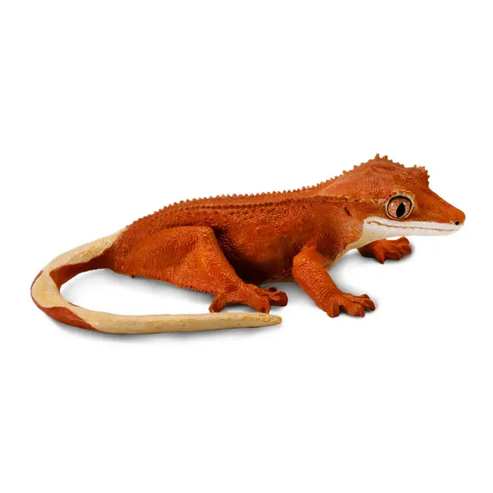 A realistic Crested Gecko toy in orange and cream colors, featuring textured skin and large eyes, posed as if walking on a white background.