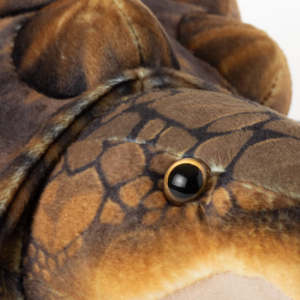Close-up of the Wild Onez Snapping Turtle 15″ (38cm) plush toy, featuring a soft, textured shell with subtle scale patterns, a large black and gold eye, and cuddly fabric—an adorable addition to any swamp-themed nursery decor.