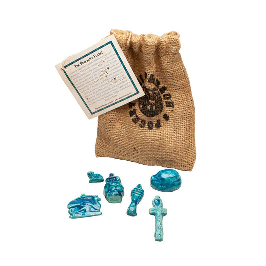 Introducing the Egyptian Pharaoh’s Pocket Amulets: a burlap bag with printed text, a small card, and seven blue-green ancient Egyptian replica artifacts—including an ankh, a sarcophagus, and other detailed figurines—beautifully displayed on a white background. These unique pieces are perfect as ancient Egypt gifts or luck amulets for anyone captivated by history and Egyptian charms.