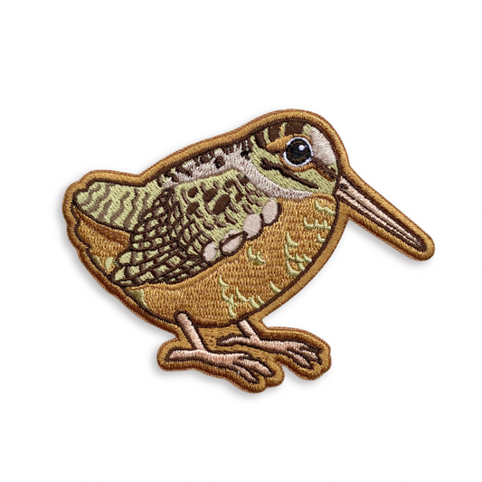 American Woodcock Iron-On Embroidered Patch featuring brown and tan mottled feathers and a long, slender beak.