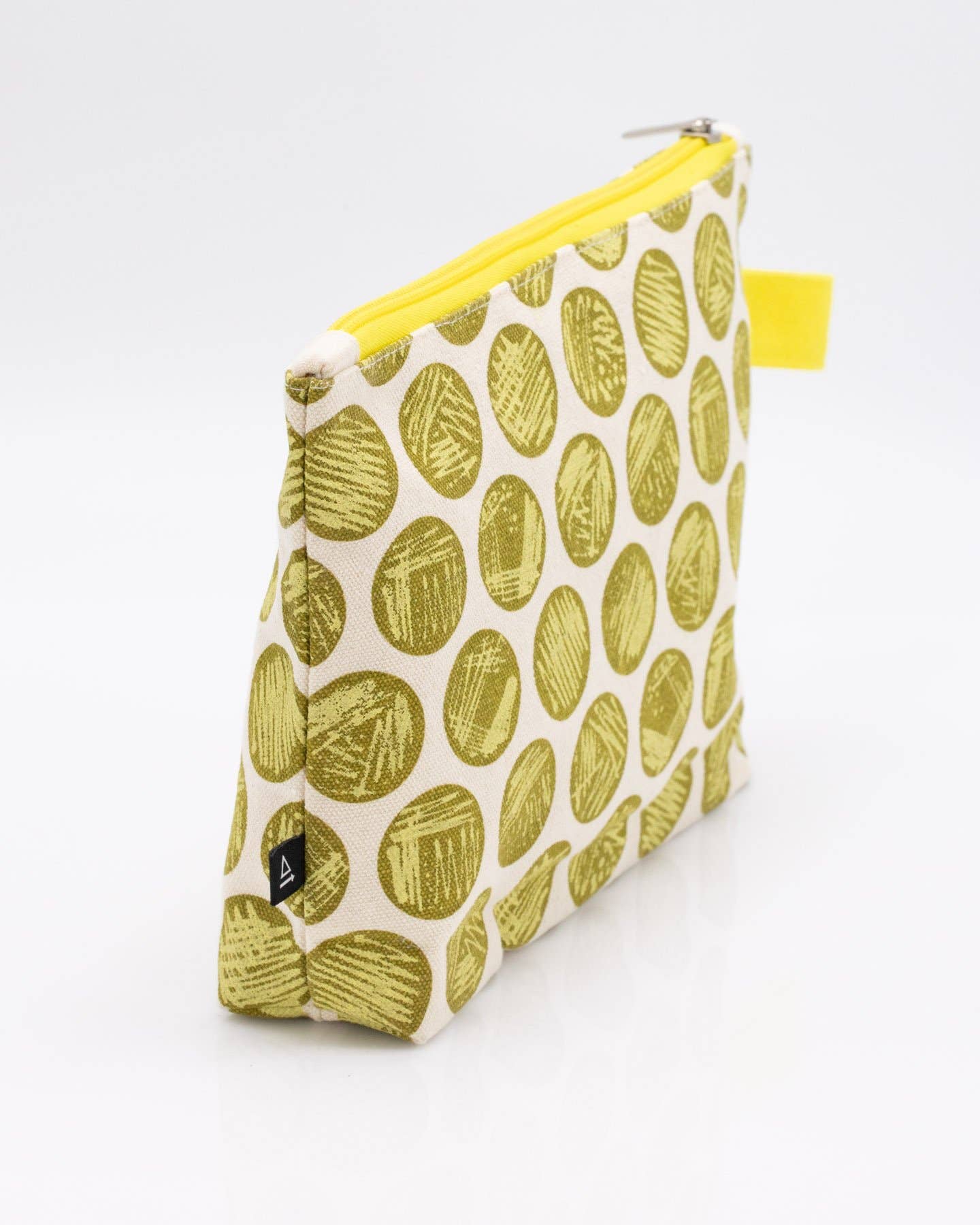 The Petri Dish Streaking Pencil Bag is a fabric pouch with a yellow zipper, featuring greenish-yellow circles like bacteria in a Petri dish—a quirky upright bag and fun microbiology gift.