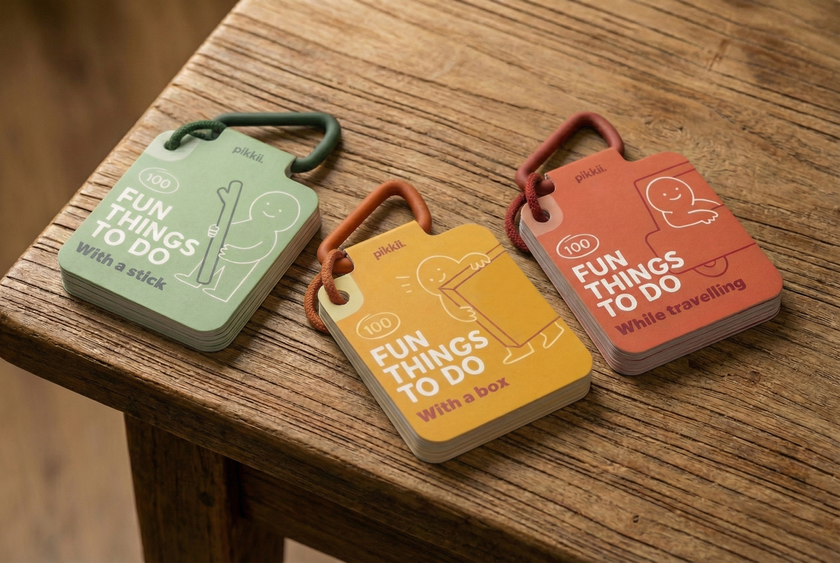 Three decks of Fun Things to do with a stick | Play and Activity Cards on carabiners, featuring activities for sticks, boxes, and travel to provide screen-free play ideas.