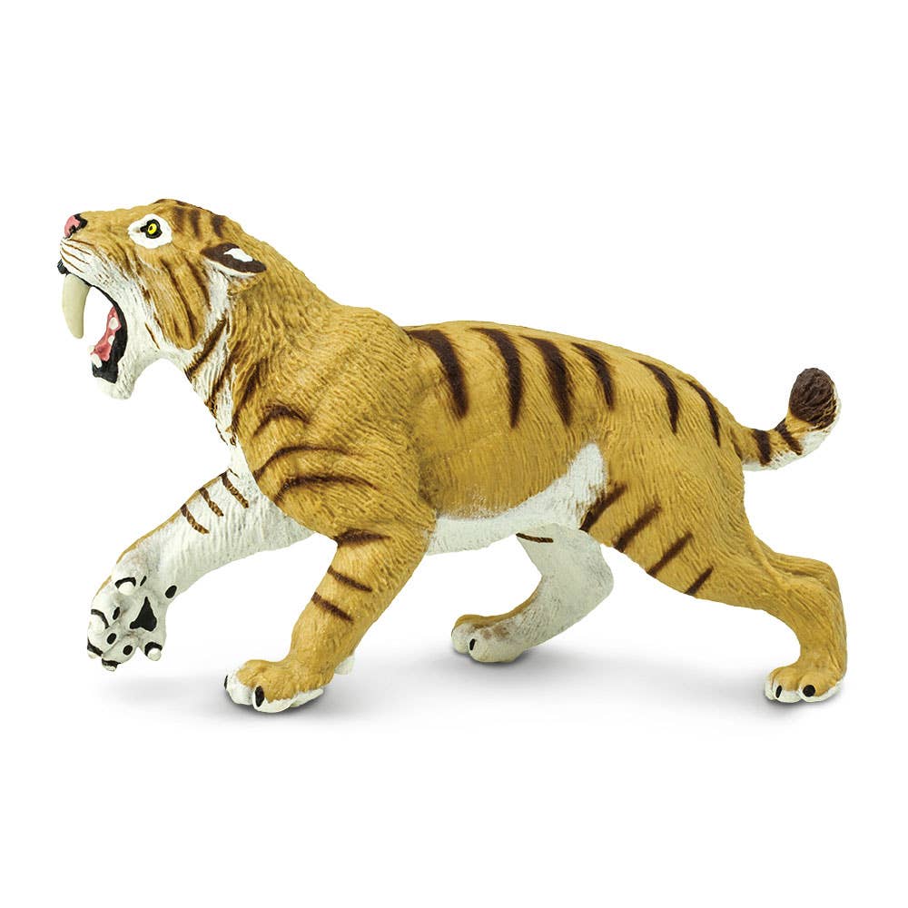 The Smilodon Saber-Toothed Cat Figurine Toy depicts a saber-toothed cat mid-roar, mouth wide open to showcase its impressive fangs. Featuring orange-brown fur with black stripes and white accents on the face, chest, and legs, this toy captures the fearsome appearance of the ancient predators discovered at the Rancho La Brea tar pits.