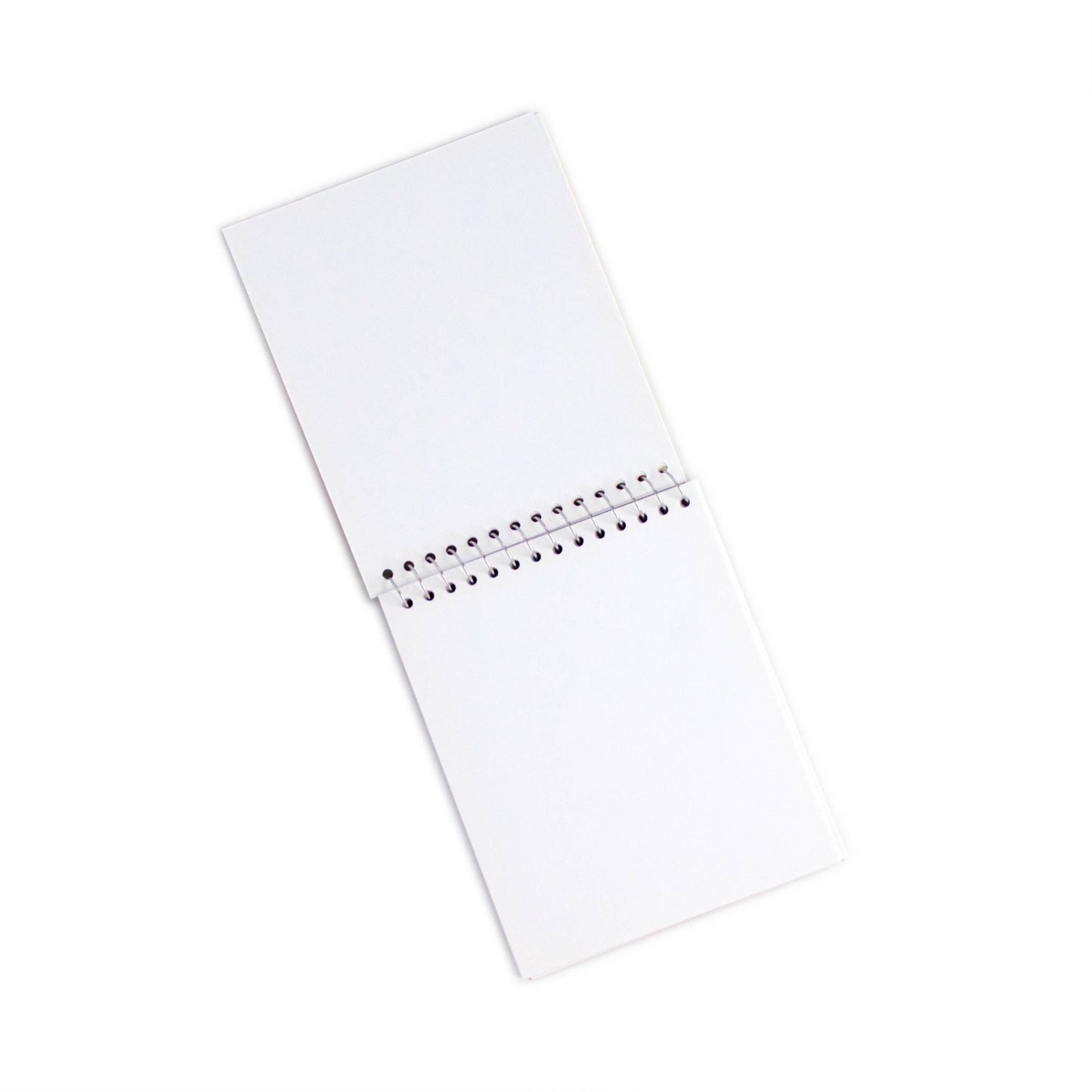 A Small Sketchbooks Dino Assortment spiral-bound notebook with blank white pages, viewed from above on a white background.