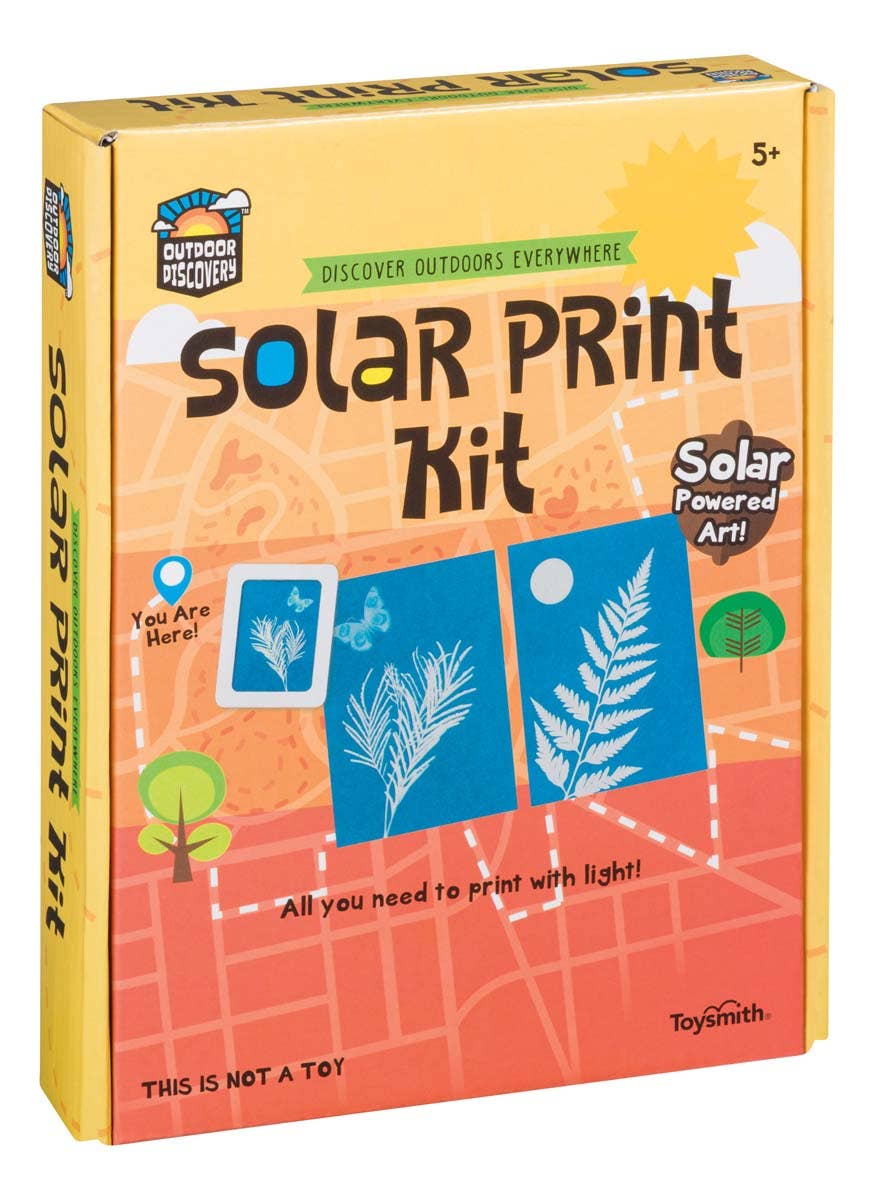 A yellow box labeled Outdoor Discovery Solar Print Kit for ages 5+, featuring solar print paper, sun prints of leaves and a flower, and the text "Solar Powered Art! All you need to make solar prints with light!" by ToySmith.