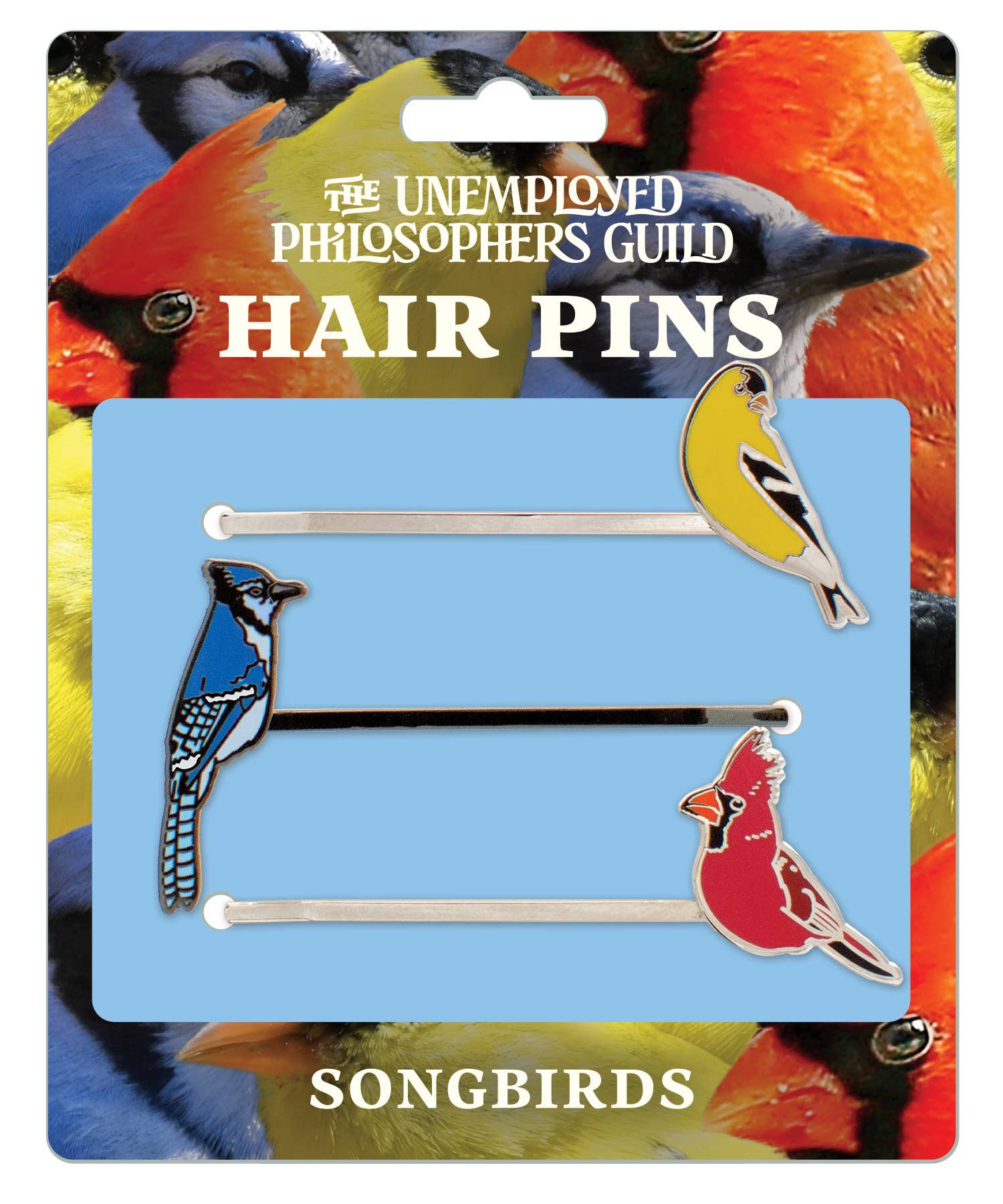 The Songbird Hair Pins feature two enamel designs—an American Goldfinch and a Northern Cardinal—mounted on pins and displayed against a background of bird photos.